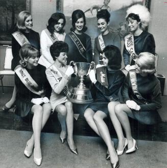 Miss Grey Cup is the title these beauties are seeking as they pose with the historic football mug
