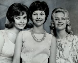 Victors in glamor game, Pretty Carol Goss (centre) won a preliminary of the Miss Toronto Contest last night at the Canadian National exhibition grands(...)