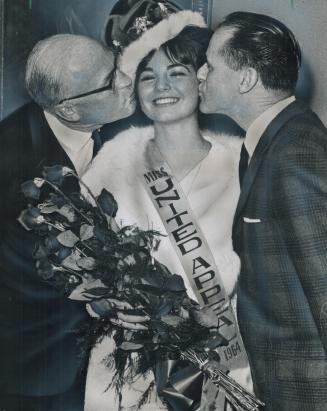 Ryerson student Margo Gibson 18, gets kisses from United Appeal chairman William Mitchell (left) and her father, William, after winning the Miss Unite(...)