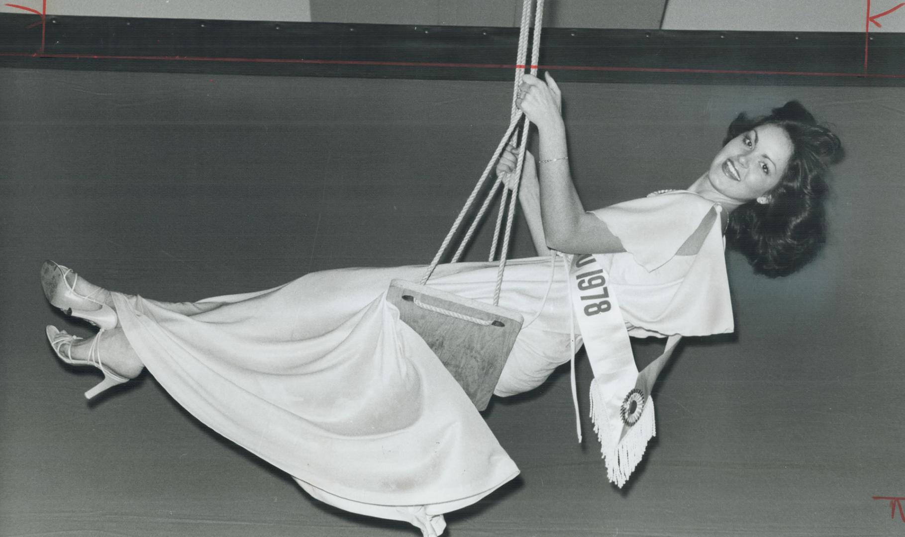 Swing into spring, Miss Toronto 1978, Carol McCartney, dangled from a swing strung from the ceiling at the Sheraton Centre as about 500 leaders of Met(...)