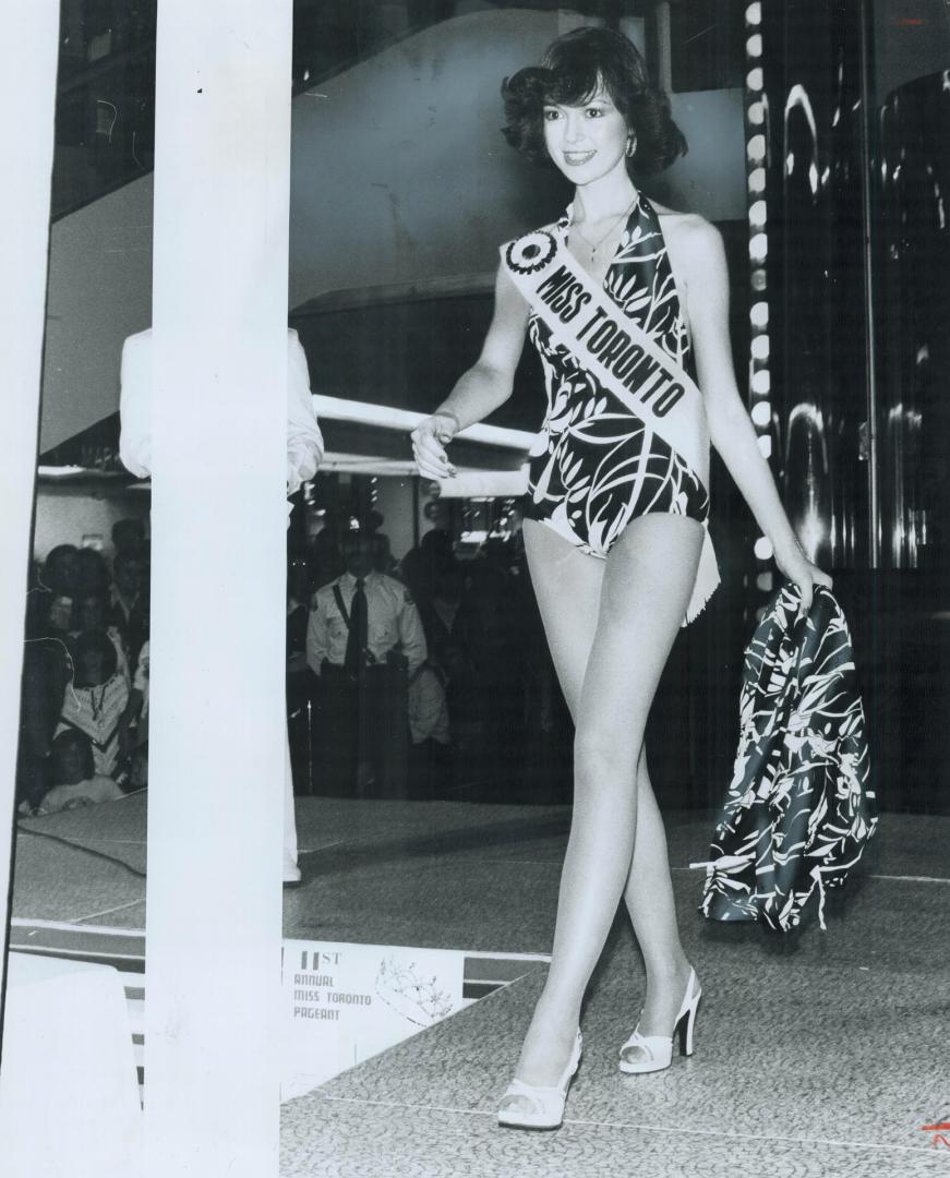 A new suit, Last year's Miss Toronto winner, Debbie Fernandez, 23, models bathing suit at Scarborough Town Centre that finalists will wear in Aug. 6 contest at Police Games in Exhibition Place