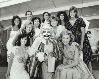 Now you know why he's 'Happy' Harry, Happy Harry the Clown had reason to smile yesterday: There he was in Nathan Phillips Square surrounded by the 10 finalists in the Miss Toronto contest