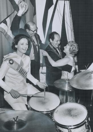 Miss Boating, Julie Paul, tries her hand at the drums to entertain dancers at the dinner dance held last night to mark today's opening of the International Boat Show