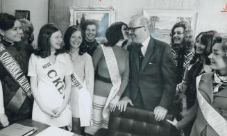 The mayor's payoff, Lorraine Ross of Maclean-Hunter Publications, kisses Mayor William Dennison as contestants in the Toronto Men's Press Club's Miss Byline competition visit City Tall