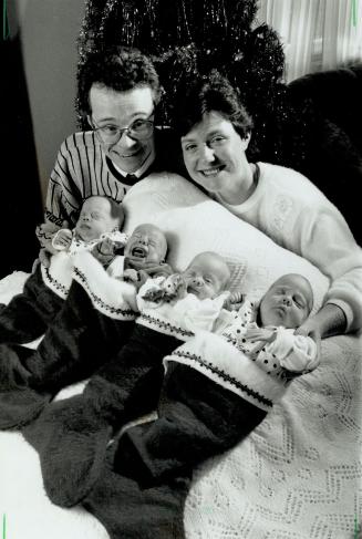 King stuffers: Frank and Mary Gallagher prepare for a busy Christmas their quadruplets (from left) Emma, Michael, Louise and Katie