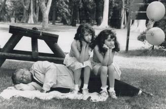 Doubling up on grandpa, While Frank Spensieri takes advantage of the warm summer weather for a snooze, his twin granddaughters Cara, left, and Lori Spensieri take time out for a rest