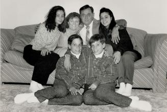 Cheerful twins and their kin: Ten-year-old Sinisa and Sasa are in front in this family portrait, behind them, from left, are Ister Deana, Mom, Dad, and their sister Daniela