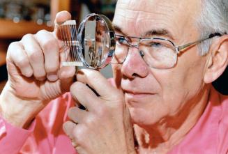 Light sensors help the blind, Frank Gill, founding member of the Scarborough chapter of the Telephone Pioneers of America, works on the circuitry for (...)