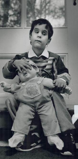 Anto Awansian examines a doll at the school operated by the Ontario Foundation for Visually Impaired Children in High Park