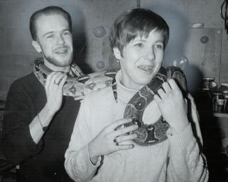 Bruce Mcbride and sister Valerie toy with Buster the boa