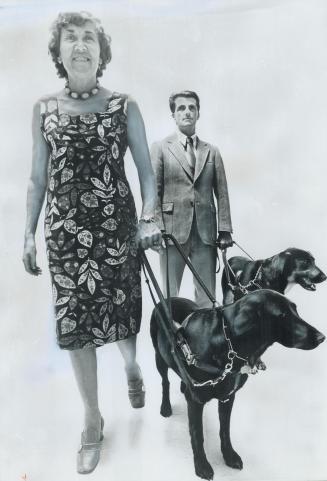 Seeing-eye dogs Boz and Duke go through their paces with their owners, Betty Jane Leadbeater and Ken London
