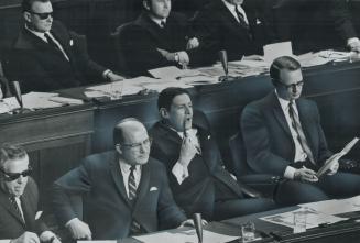 Liberal members listen with critical ears to yesterday's Ontario budget presentation by Provincial Treasurer Charles MacNaughton. From left, Edward Sa(...)