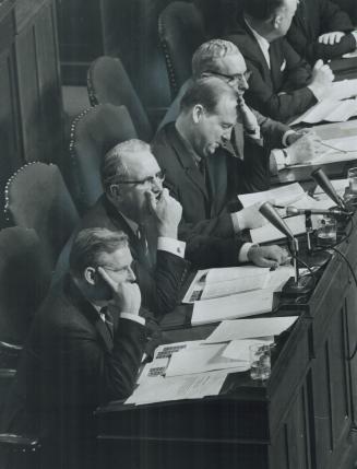 NDP members listen unreceptively at Queen's Park yesterday to budget speech