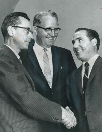 Winner Dr. John Farina, left, is congratulated by Ragno, With them is NDP leader Donald C. MacDonald