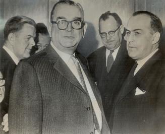 After private session with Mr. Hees, the M.P.s leave his office. From left: Works Minister E. Davie Fulton, unidentified man in foreground, Citizenshi(...)
