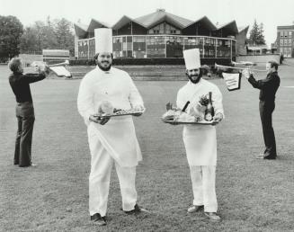 Showing off: Church chef Terry Seed (left) and Rundels chef Neil Baxter with hams on their Baxter with hams on their platters - symbolizing some of the action in the Festival Theatre behind?