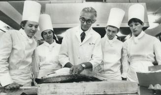Apprentice chefs on their way to Frankfurt to compete in the Olympics for Canada watch George Brown College Chef Willie Brand prepare fish. From left,(...)