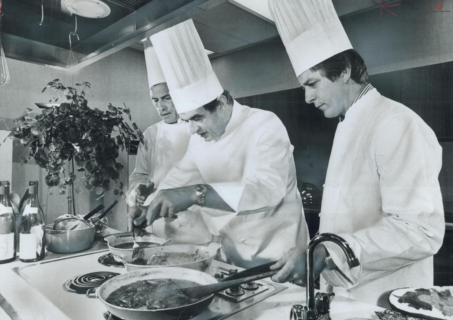 Chef Paul Bocuse, centre, swiftly works his culinary magie in The Star test kitcher day, as Chef Marcel Didier, of the Royal Y and Chef Francis Vanden(...)