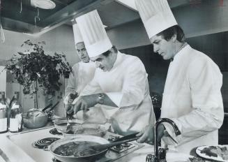 Chef Paul Bocuse, centre, swiftly works his culinary magie in The Star test kitcher day, as Chef Marcel Didier, of the Royal Y and Chef Francis Vanden(...)