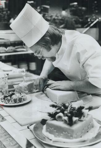 Deft touch of pastry chef Ernest Frehner gives a rich Christmas cake the royal treatment it deserves with marzipan (almond paste). The Windsor Arms Ho(...)