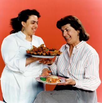 Pastry chef Renee Foote, left, trades her recipe for Hazelnut Biscotti for a taste of vegetarian Eggplant Lasagna from her mother, Ruth