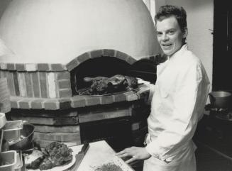 Open kitchen: Chef James Lutes presides over the asador, the wood-burning oven, at La Ina