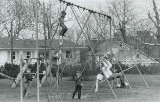 Happy children having a ball in playground are house guests of the Salvation Army in the new homes provided for them on Broadview Ave. Termed The Cott(...)
