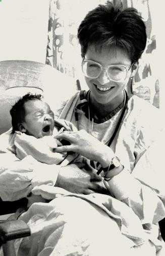 Baby Janey, the 24-hour-old girl found abandoned under a tree in a Scarborough hydro corridor yesterday, is rocked by nurse Terry Barry at Scarborough(...)