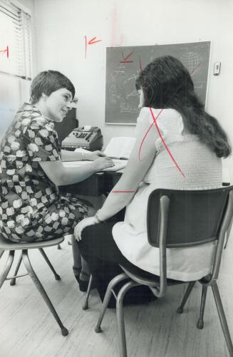 One-to-one basis tutoring by teachers, like Judy McKnight, help unwed mothers keep up with school