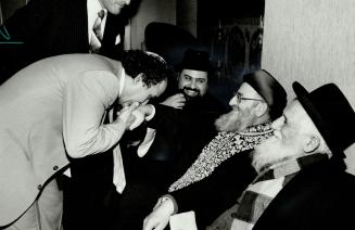 Chief Sephardic rabbi in town, Montreal Rabbi Mosche Suissa kisses the hand of Rabbi Mordechai Eliyahu, leader of the world's 3 million Sephardic Jews(...)