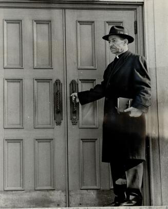 Locked Out!, Rev. Haralampy Elieff, centre of a dispute at Sts. Cyril and Methody Church, finds door locked as he arrives for service yesterday