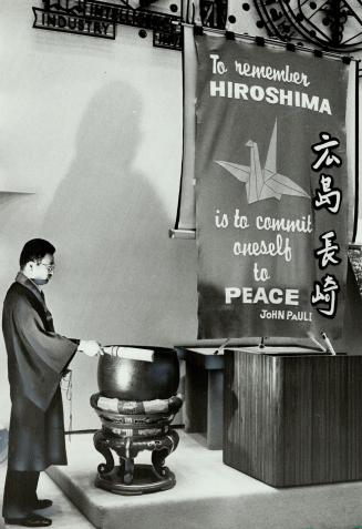 Striking for peace: Rev. Orai Fujikawa strikes a Buddhist gong 36 times - once for every year the world has survived since the first atomic bombs were dropped