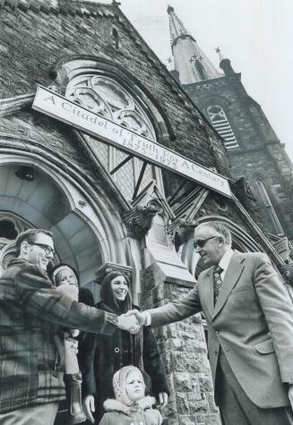 New Pastor at Jarvis St. Baptist Church, Rev. Eric Gurr, shakes hands with Glenn Terrell, holding Elizabeth, 2, while his wife, Jeannette, and Heather(...)
