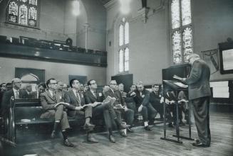 Hardnosed Businessmen, academics and professional men listen to Rev