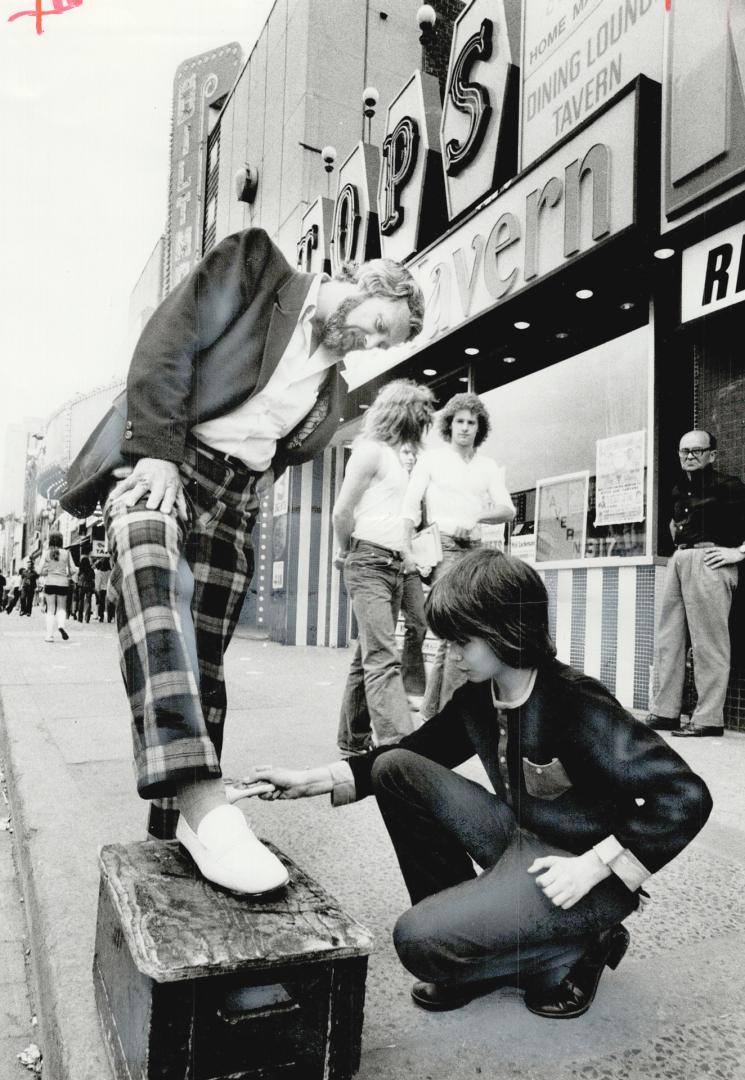 The Yonge St. Strip saddens rather than shocks Rev. Fred Miller of Holy Trinity Anglican Church, getting his shoes cleaned on the strip by Philip Rutt(...)