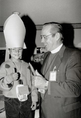 Bishop for a day: Brett Belcher, 7, now knows a lot more about bishops than before, thanks to the Right Reverend Taylor Pryce, Bishop of York-Simcoe