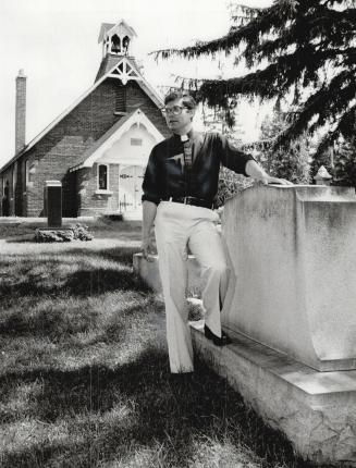 Looking back: Rev. Jack Roberts stands in the old graveyard of St. Margaret in the Pines Anglican Church in Scarborough which is marking its 150th anniversary this year with several special events