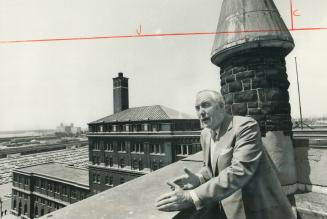 From the roof of St. Andrew's Presbyterian Church at King and Simcoe Sts., Rev. Douglas Stewart surveys the area which will be redeveloped