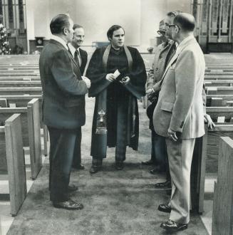 After sunday service, Oshawa minister Gordon Turner talks with members of his congregation