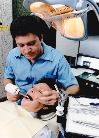Bonding breakthrough: Above, Etobicoke dentist, Dr. Hugh Kinkartz, uses the new bonding technique on a patient. Left, a gap between front teeth, top, (...)