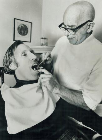 Fifty-three years of almost ouch-less dentistry has been enough for Dr. John Stephens Wilkinson, 72. Here he treats one of the last of his patients, Bob McLaughlin