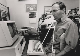Success story: Quadriplegic computer programmer Lew Boles shows typing technique yesterday at Queen Elizabeth Hospital during National Occupational Therapy Week