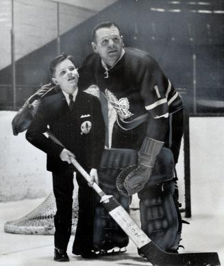 Timmy gets a goalie lesson. Jimmy Charles McMillan of Windsor, this year's Timmy, gets some netminding tips from Leafs' Johnny Bower. It was one of th(...)
