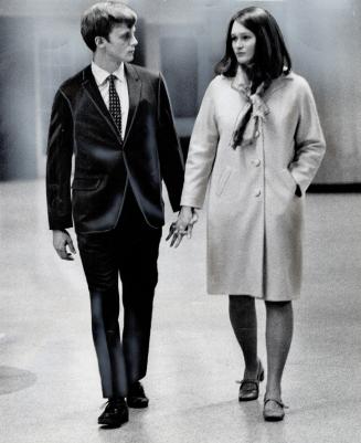 Hand in Hand, David Schwartz, 21, and his wife, Ann, 22, walk through Union Station to take the train back to the United States where David faces poss(...)