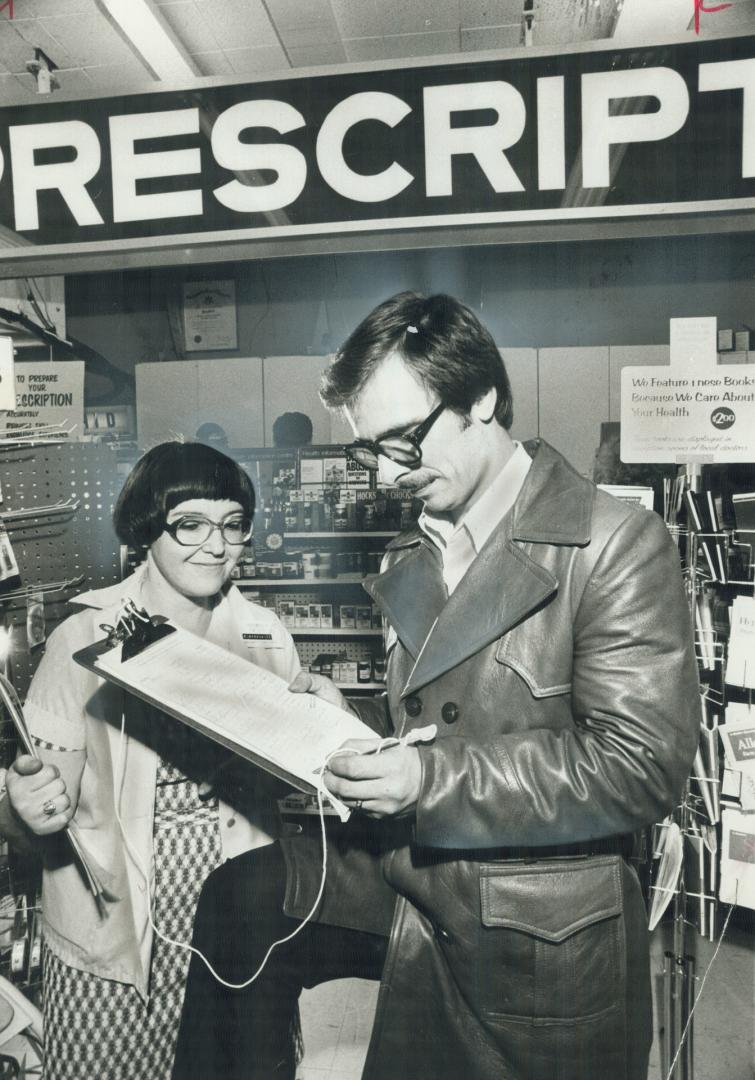 In a one-woman campaign, pharmacist Roza Berkowitz gets signature of customer George Hollett, of Jane St