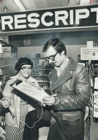 In a one-woman campaign, pharmacist Roza Berkowitz gets signature of customer George Hollett, of Jane St