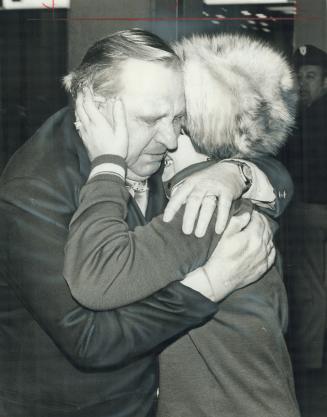 Karl Graf hugs one of his three daughters, Rosa, 35, at Toronto airport last night