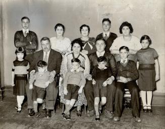 Mr. and Mrs. Steffano Darrigo of Toronto, and their family of 12. Mrs. Darrigo claims that she has had nine children since Oct. 31, 1926. This place h(...)
