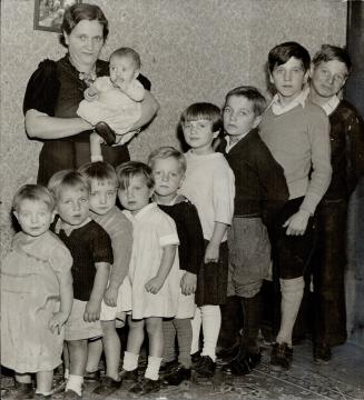 Mrs. Kittis, who claims eight of her 11 children are eligible, is seen in (2) with her family. Left to Right are