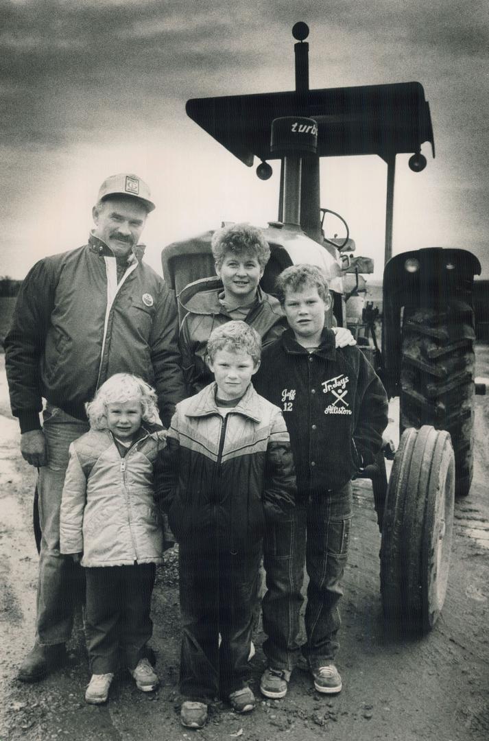 Model farmers: Housing and industries are spreading across Alliston, but the Morrisons - John, Pat and Emily, 5, David, 8, and Jeffrey, 10 - are taking the changes in stride